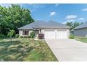 Beautiful brick home with a two-car garage and a well-manicured lawn showcasing lovely curb appeal at 1238 Passage Way, Plainfield, IN 46168
