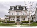Charming two-story home with a classic design, featuring a welcoming front porch and landscaped garden at 12813 Chapel Square St, Carmel, IN 46032