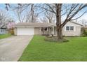 Charming brick ranch home featuring an attached garage and a well-maintained front lawn at 1313 Roseway Dr, Indianapolis, IN 46219