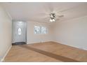 Bright, empty living room featuring neutral walls, wood-look flooring, and a ceiling fan at 1313 Roseway Dr, Indianapolis, IN 46219