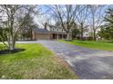 Traditional home with a long driveway and attached two-car garage at 1320 Bittersweet Dr, Greenfield, IN 46140