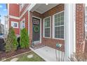 Inviting front porch featuring brick accents and a decorative wreath on the front door at 13245 E 131St St, Fishers, IN 46037