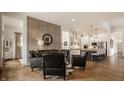 Open-concept living room with hardwood floors, neutral wall colors, and seamless access to the modern kitchen at 1395 Chatham Hills Blvd, Westfield, IN 46074