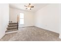 Bright bedroom with a staircase, window, and neutral carpeting at 1403 Lafayette Ave, Columbus, IN 47201