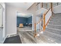 Spacious foyer with hardwood floors, a staircase with wooden railings, and a view into a cozy living room at 14720 Warner Trl, Westfield, IN 46074