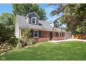 Well-kept brick home with green lawn and mature trees at 1528 N Dukane Way, Indianapolis, IN 46214