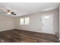 Bright living room with modern ceiling fan, luxury vinyl flooring, and large windows at 1528 N Dukane Way, Indianapolis, IN 46214