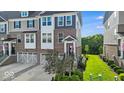Attractive townhouse exterior with gray and brick, showcasing a well-maintained lawn and garden at 16060 Barringer Ct, Westfield, IN 46074