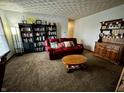 Cozy living room featuring a red leather sofa, built-in bookshelf, and a decorative hutch at 1706 Manor Dr, Lebanon, IN 46052