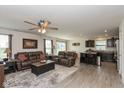 Open-concept living area with dark kitchen cabinets and comfortable leather sofas at 181 Kiawah Dr, Whiteland, IN 46184