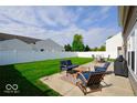 Relaxing patio area with comfortable seating, a coffee table, and a manicured lawn perfect for outdoor enjoyment at 2009 Quarter Path Rd, Cicero, IN 46034