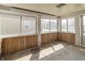 Sun room with wood paneling, multiple windows, and abundant natural light at 218 Illinois St, Shirley, IN 47384