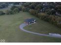 Sprawling property showcasing a modern home with an attached garage and a long, curved driveway at 2428 S Morgantown Rd, Greenwood, IN 46143