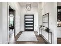 Elegant foyer with modern lighting, a console table, and a view into the adjacent living space at 2428 S Morgantown Rd, Greenwood, IN 46143