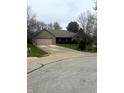 A brick home featuring an attached garage, complemented by a green lawn and paved driveway at 2690 Trailridge Ct, Martinsville, IN 46151