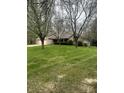 A charming brick home with green lawn and mature trees providing a picturesque suburban setting at 2690 Trailridge Ct, Martinsville, IN 46151
