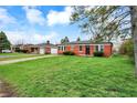 Well-maintained brick home with a lush green lawn and inviting curb appeal at 2828 N Moreland Ave, Indianapolis, IN 46222