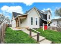 An eye-level shot shows a well-manicured lawn and inviting entrance to this cozy home at 305 Sanders St, Indianapolis, IN 46225