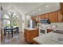 Bright kitchen with stainless steel appliances, oak cabinetry, and adjacent breakfast nook at 36 Palomino Ct, Zionsville, IN 46077