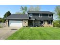 Charming two-story home with a well-manicured lawn and a two car garage at 3771 Lakewood Dr, Greenfield, IN 46140