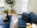 Bright living room with modern furniture and decor, featuring large windows that invite plenty of natural light at 414 Glendale Dr, Columbus, IN 47201