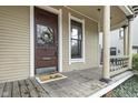 Close up of the front porch with a 'hello' welcome mat and wood door at 434 E New York St, Indianapolis, IN 46202