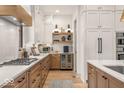 Spacious kitchen showcasing sleek countertops, a gas range, modern appliances, and custom cabinetry at 583 Exmoor Dr, Carmel, IN 46032