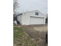 The detached garage offers parking and storage, with a basketball hoop for recreation at 6206 W Us Highway 40, Stilesville, IN 46180