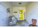Inviting front porch with a swing, decorations, and a bright yellow door at 6431 Meadowpond Way, Indianapolis, IN 46235