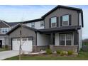 Two-story home with dark trim accents, a well manicured front lawn, and a two-car garage at 6925 Sable Point Dr, Brownsburg, IN 46112
