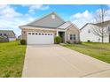 Inviting exterior view of a single-Gathering home with a lush green lawn and a spacious driveway leading to an attached garage at 7574 Merrick Dr, Brownsburg, IN 46112