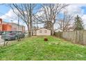 Large backyard area with grass, fence, and a detached garage at 953 N Oakland Ave, Indianapolis, IN 46201