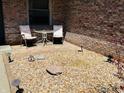 Cozy front patio area with stone, outdoor seating, and brick wall at 1030 Pamela Dr, Plainfield, IN 46168
