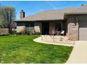 Charming brick home featuring a landscaped front yard and inviting front patio area at 1030 Pamela Dr, Plainfield, IN 46168