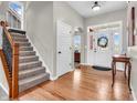 Inviting foyer showcasing hardwood floors, staircase and lots of natural light at 10603 Hinterland Dr, Fishers, IN 46038