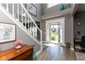 Bright foyer with a staircase, decorative accents, and an open view to the front door and exterior at 11050 Midnight Pass, Fishers, IN 46037