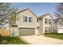 Attractive two-story home showcasing a two-car garage, complemented by neutral siding and brick accents at 12344 Bearsdale Dr, Indianapolis, IN 46235