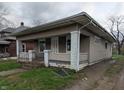 Exterior view of a modest home with a covered front porch and small front yard at 1524 Ohio Ave, Anderson, IN 46016
