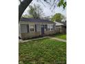Charming one-story home with stone accents, blue shutters, and a well-maintained lawn at 1806 Asbury St, Indianapolis, IN 46203