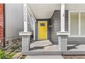 Inviting front porch featuring classic columns and a vibrant yellow door at 2006 Lexington Ave, Indianapolis, IN 46203