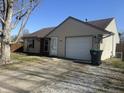 Charming single-story home with an attached garage, complemented by a green lawn and a clear, sunny sky at 265 Bittersweet Dr, Whiteland, IN 46184
