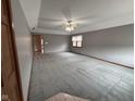 Spacious carpeted living room with a ceiling fan and natural light from a window at 2856 Colony Lake East Dr, Plainfield, IN 46168