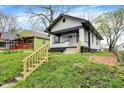 A beautifully renovated house with a covered porch and a sloping green lawn leading up to the house at 2915 E 19Th St, Indianapolis, IN 46218