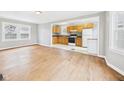 Open living room and kitchen featuring hardwood floors and natural light, perfect for entertaining at 2920 Lincoln St, Anderson, IN 46016