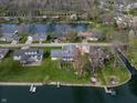 Aerial view of waterfront property with lake access, docks, and lush greenery at 315 Sunset Dr, Columbus, IN 47201