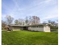 Well-maintained home featuring a spacious lawn and serene lake views at 315 Sunset Dr, Columbus, IN 47201