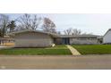 Charming single-story home with a manicured lawn and a welcoming blue front door at 315 Sunset Dr, Columbus, IN 47201