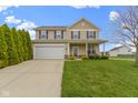 Charming two-story home featuring a well-manicured lawn and attached two-car garage at 3511 Limesprings Ln, Whitestown, IN 46075