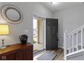 Bright foyer with hardwood floors, staircase, and decorative mirror, creating a welcoming entrance at 3511 Limesprings Ln, Whitestown, IN 46075