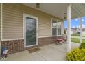 Inviting front porch with seating, brick accents, and decorative features by the door at 3511 Limesprings Ln, Whitestown, IN 46075